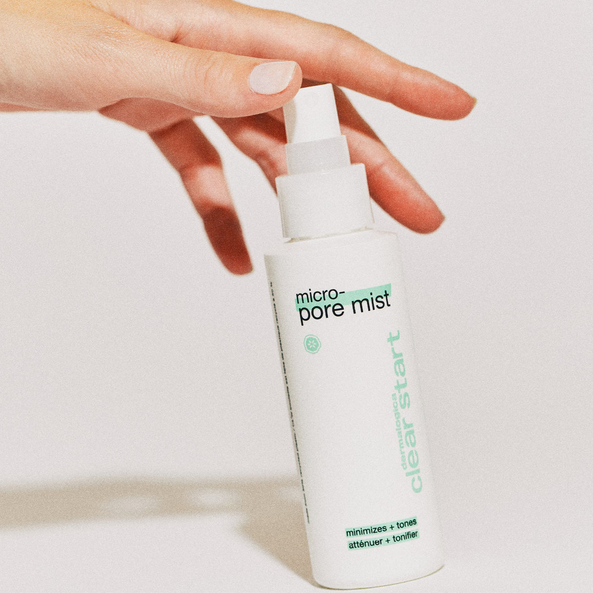 Hand touching Micro-Pore Mist 